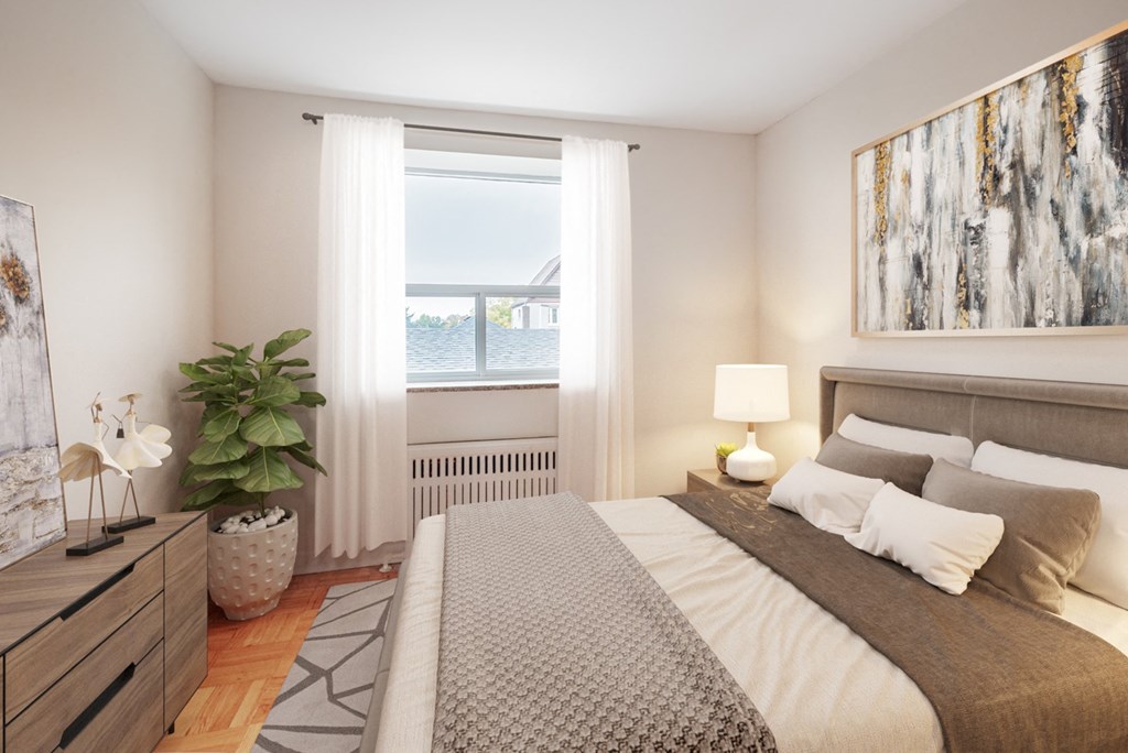 A bedroom with a large bed, a potted plant, and a painting on the wall.