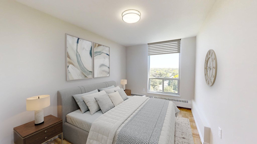 A bedroom with a large bed and a painting on the wall.