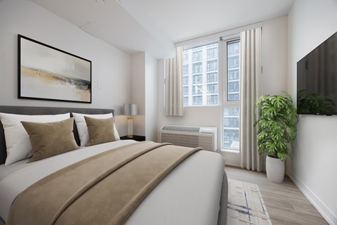 A bedroom with a large bed and a painting on the wall.