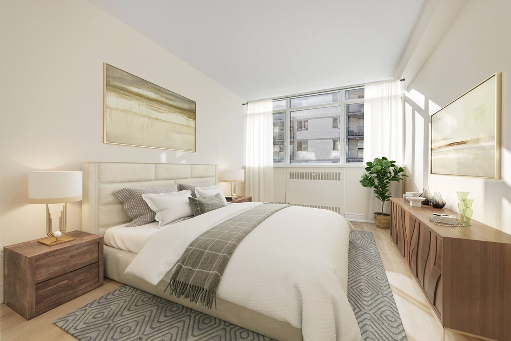 A bedroom with a large bed and a lamp on a side table.