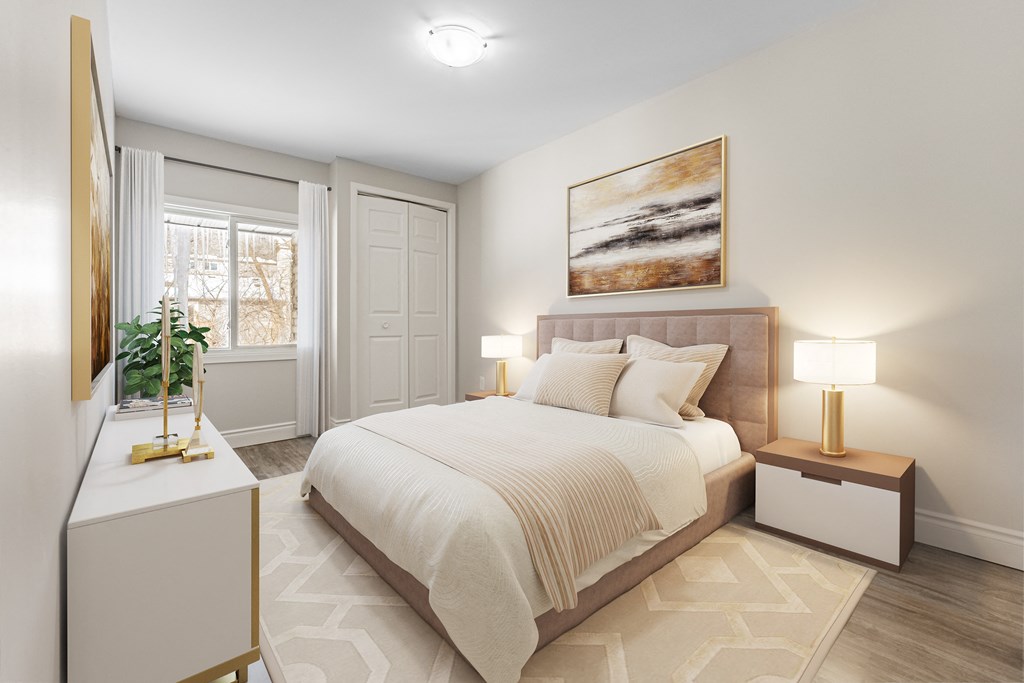 A bedroom with a large bed, a nightstand with a lamp, and a painting on the wall.