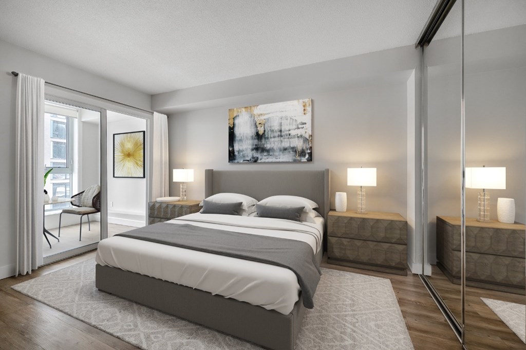 A modern bedroom with a large bed and a painting on the wall.