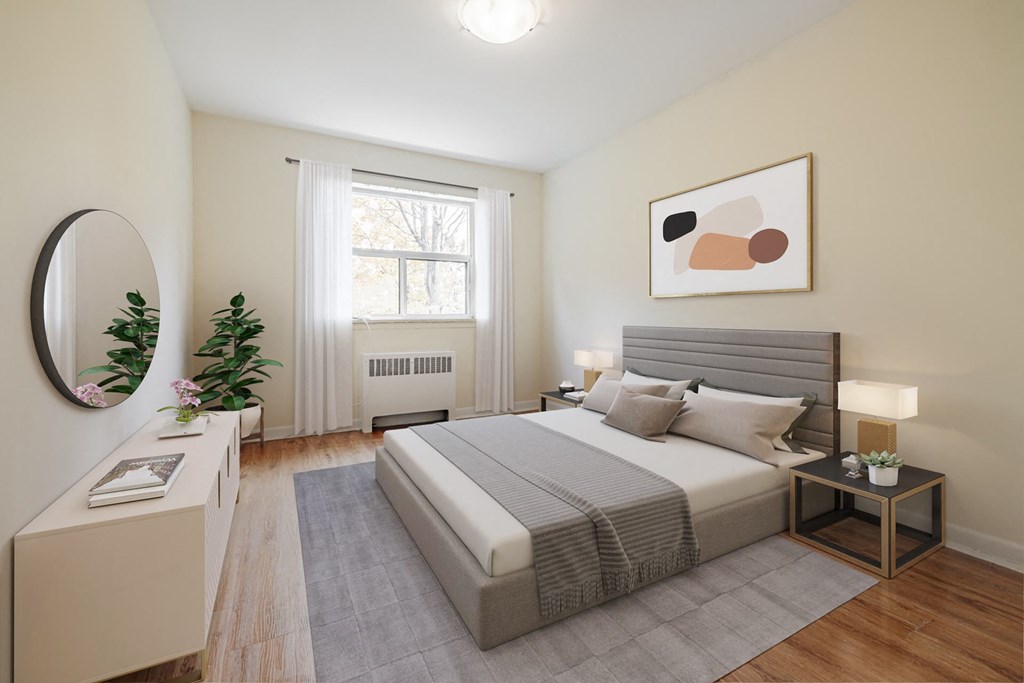 A bedroom with a large bed, a nightstand, and a window with curtains.