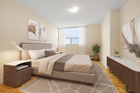 A bedroom with a large bed and a plant on the side table.