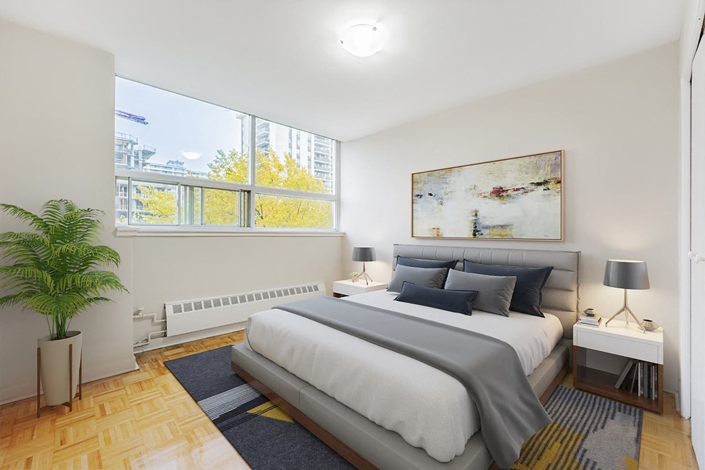 A bedroom with a large bed and a painting on the wall.