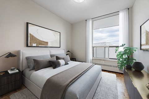 A bedroom with a large bed and a view of a bridge through the window.