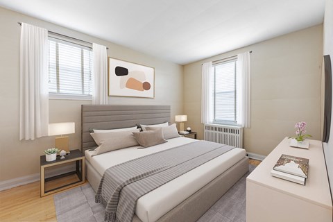 A bedroom with a large bed and a painting above it.