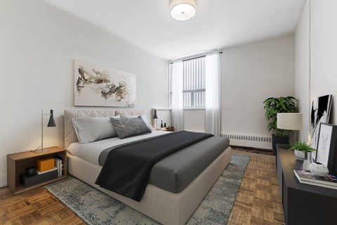 A bedroom with a large bed and a painting on the wall.