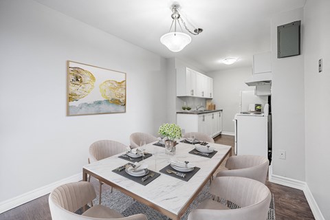 A dining room with a table set for four.
