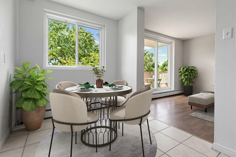 A dining room with a table set for four.