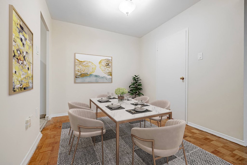 A dining room with a table set for four.