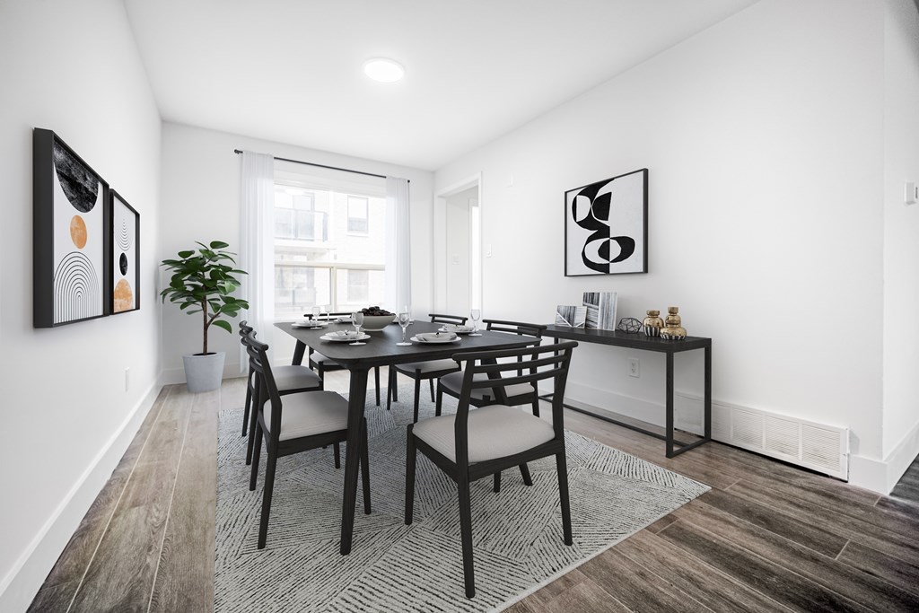 A dining room with a table and chairs.