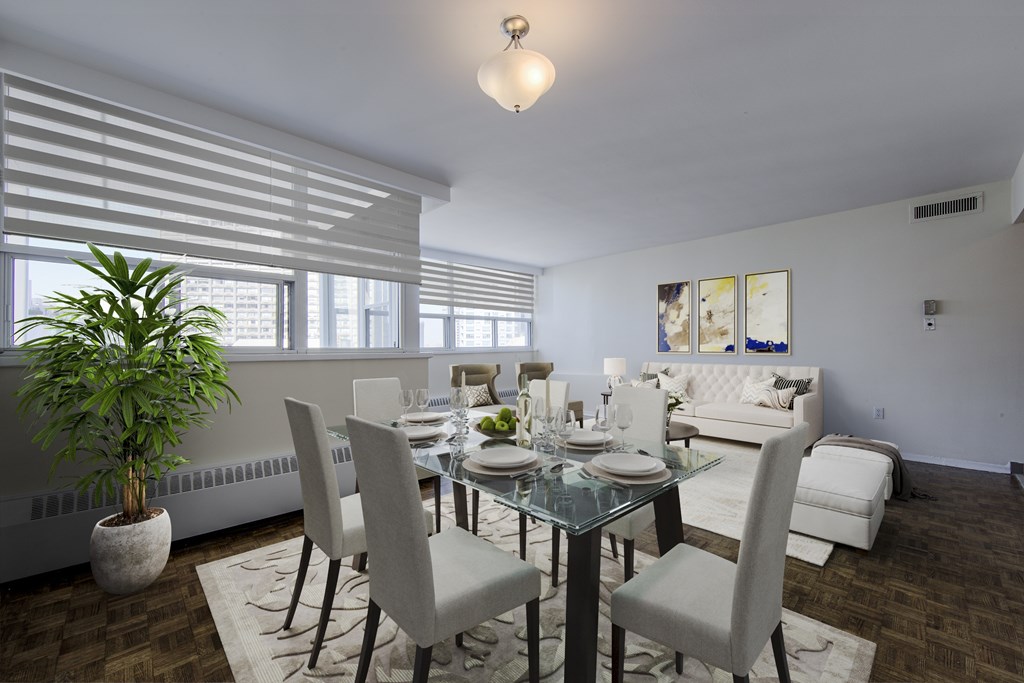 A dining room with a glass table and chairs.