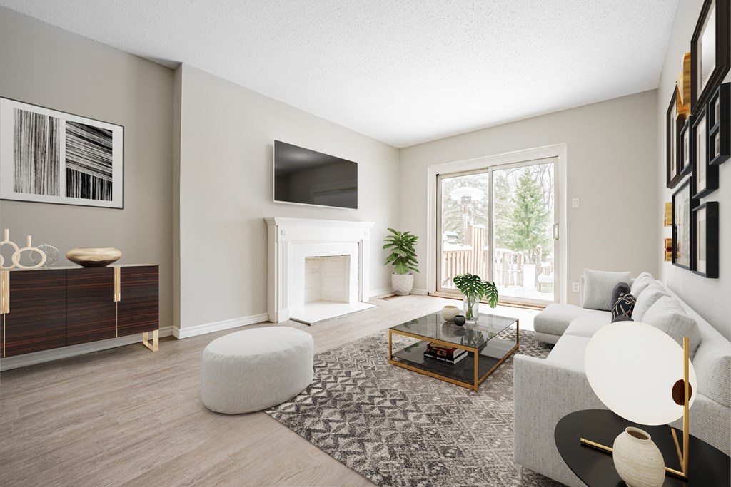 A modern living room with a grey sofa, a coffee table, and a TV on the wall.