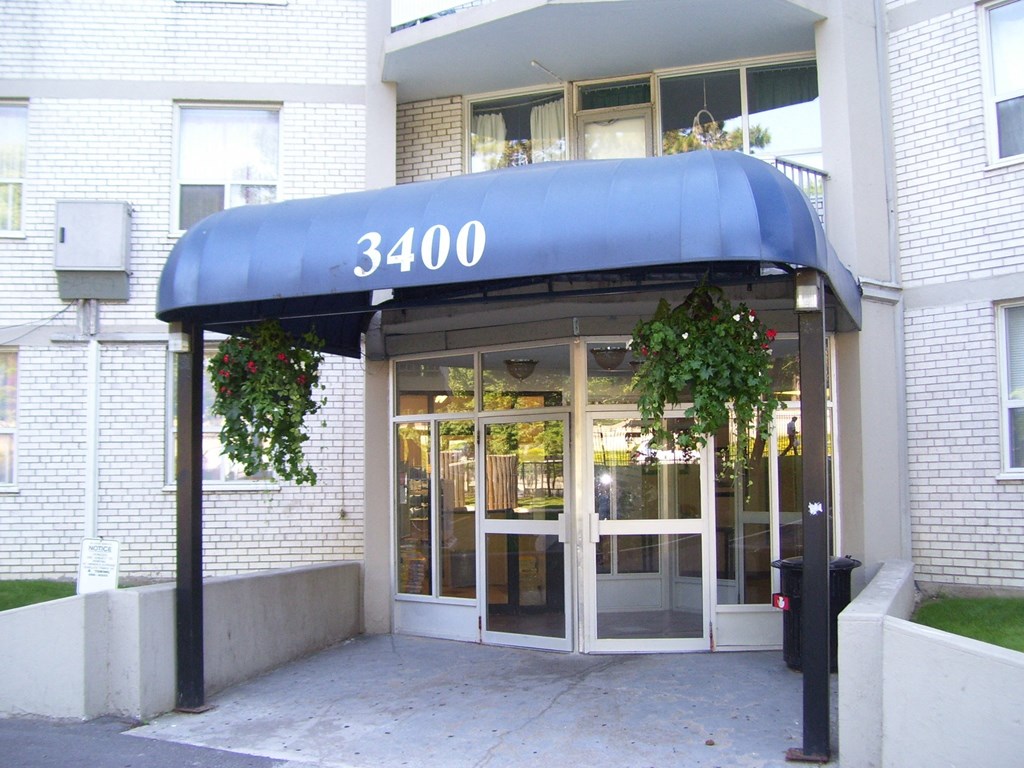 The entrance to a building with the number 3400 on the awning.