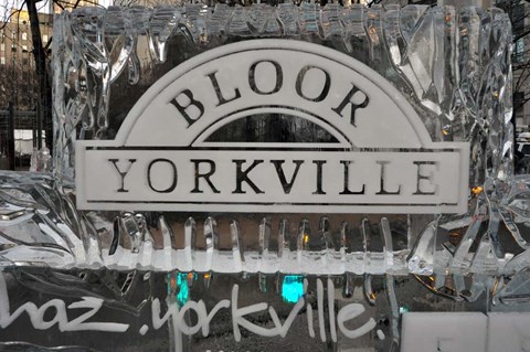 A sign that says Bloor Yorkville is covered in ice.