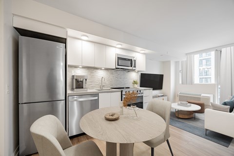A modern kitchen with a dining table and chairs.
