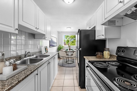 A modern kitchen with a black stove top oven.