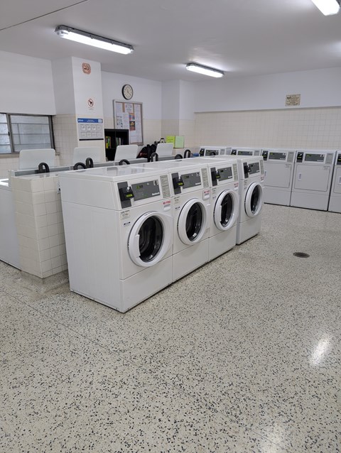 A row of washing machines in a laundromat.
