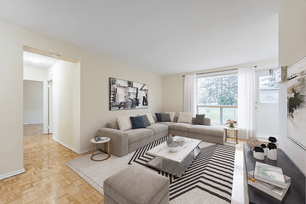 A living room with a grey couch and a coffee table.