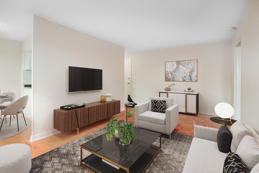 A modern living room with a flat screen TV mounted on the wall.