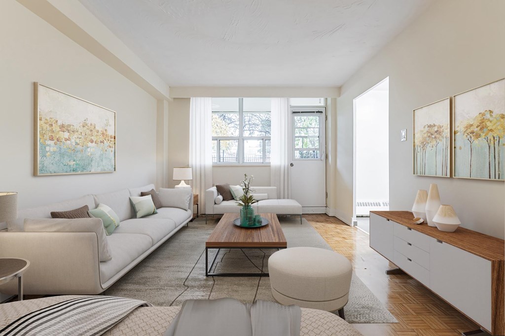 A living room with a white couch, a coffee table, and a painting on the wall.