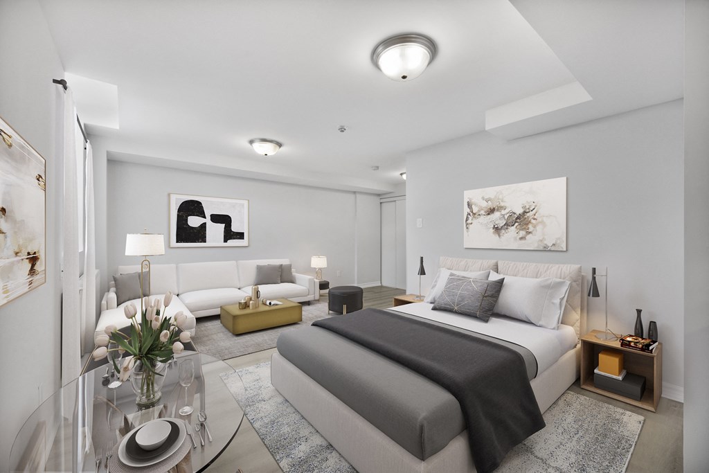A modern bedroom with a large bed and a glass coffee table.