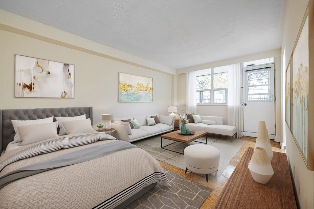 A bedroom with a large bed and a white couch.