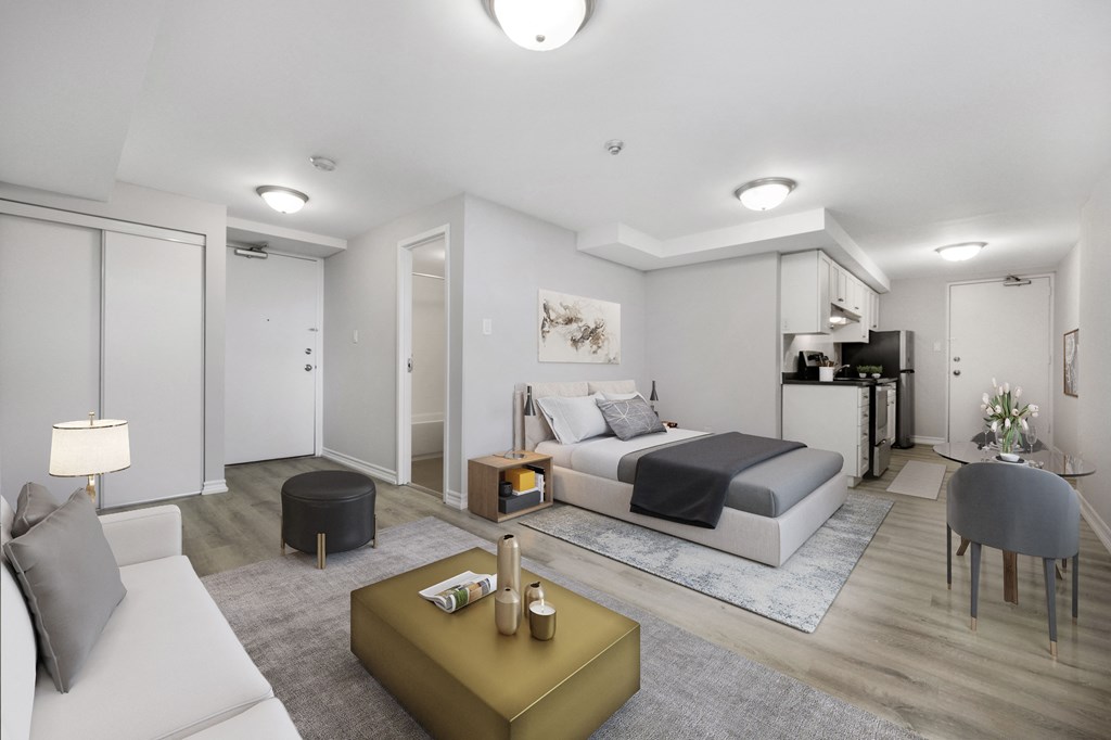 A modern bedroom with a large bed and a white couch.