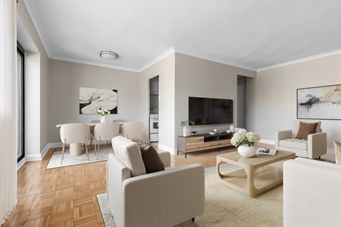 A living room with a white sofa set and a wooden coffee table.