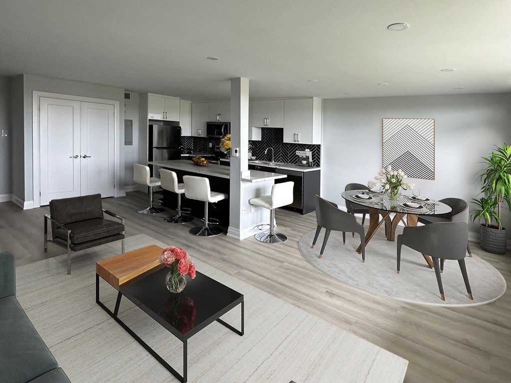 A modern kitchen and dining area with a black coffee table and white chairs.