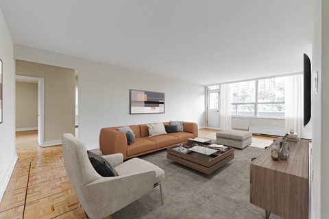 A living room with a grey sofa, a grey armchair, a coffee table, and a television.