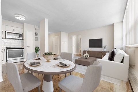 A modern dining room with a round table and grey chairs.