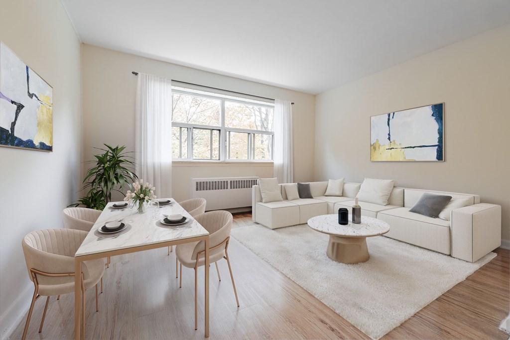 A white living room with a dining table and chairs.