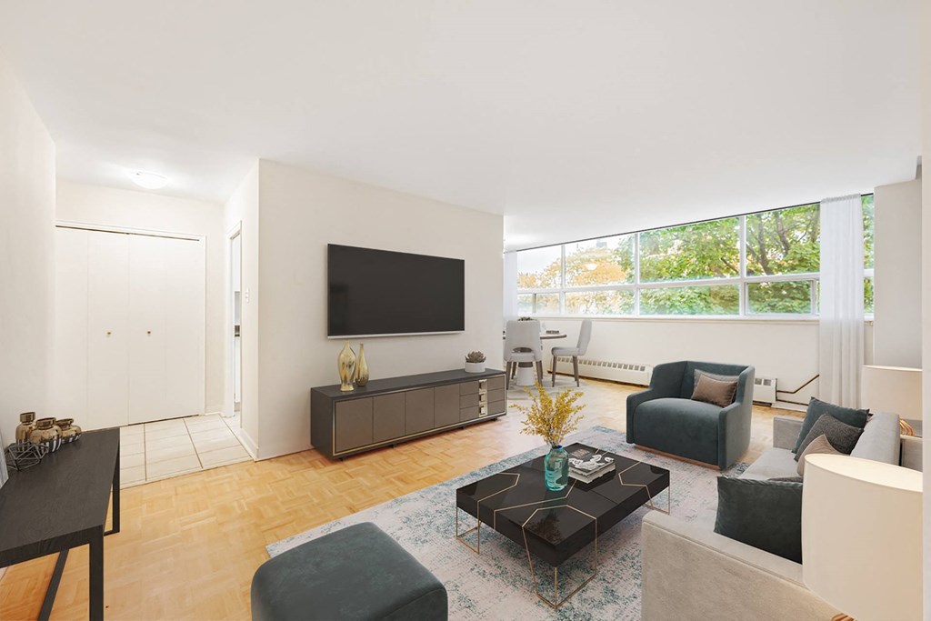 A living room with a black coffee table and grey couches.