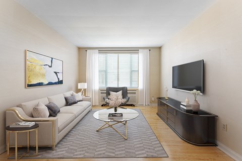 A living room with a couch, coffee table, and television.