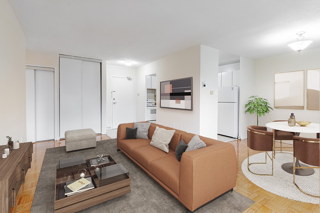 A living room with a brown couch and a coffee table.