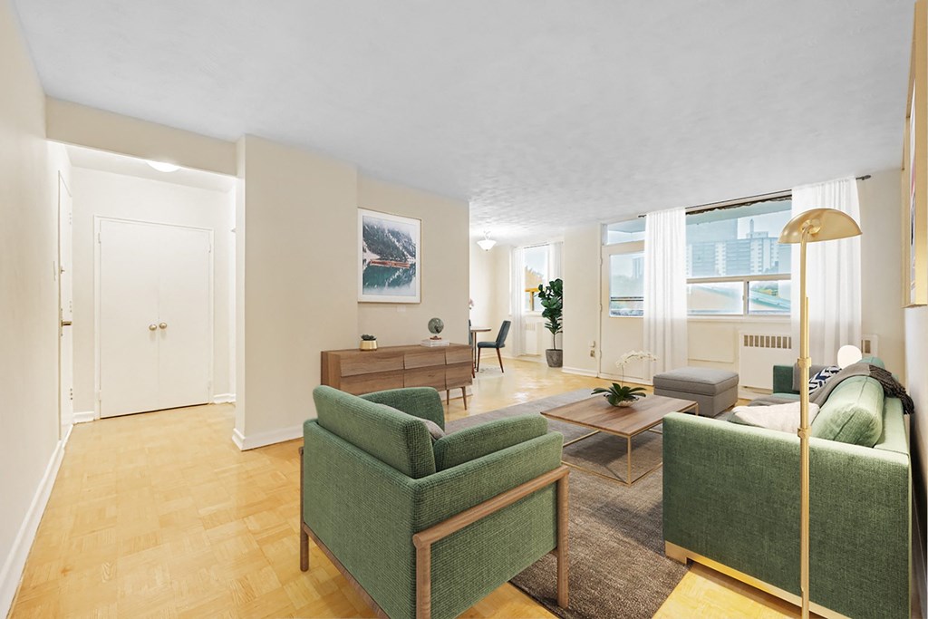 A living room with a green chair and a brown table.