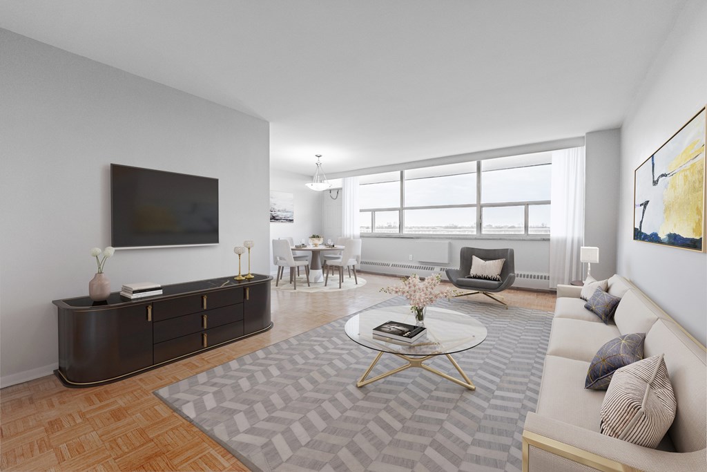 A living room with a grey rug and a white sofa.