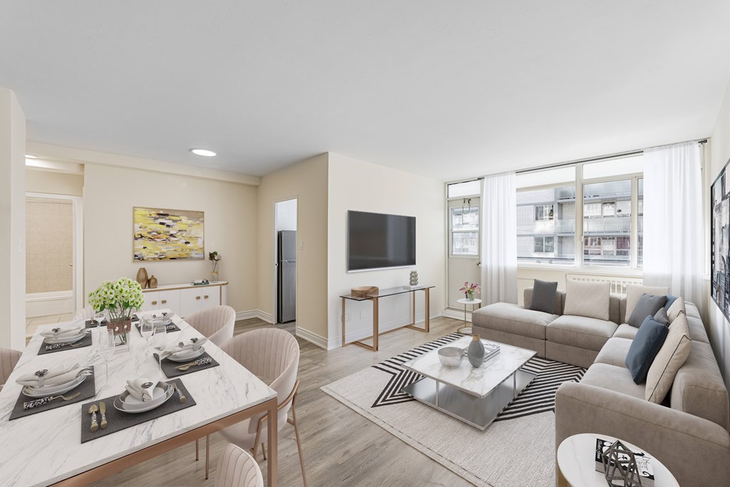 A modern living room with a dining table set for two.