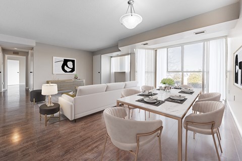 A modern dining room with a white table and chairs.