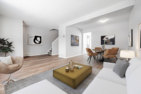A living room with a white couch, a yellow coffee table, and a chair.
