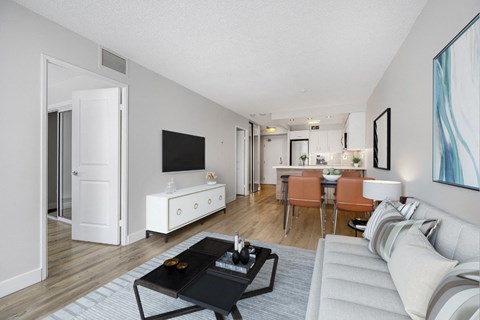 A living room with a white couch and a black coffee table.