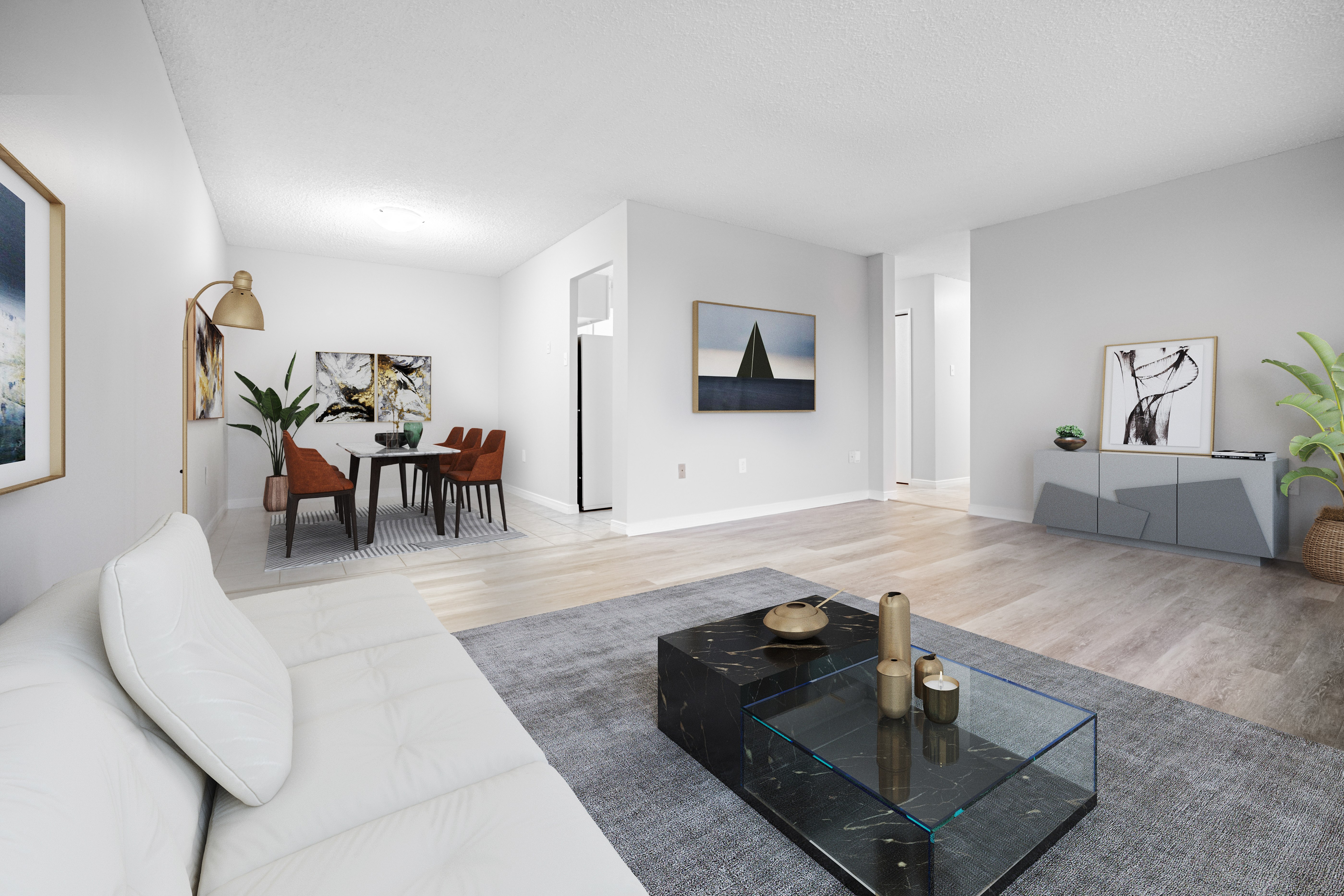 A modern living room with a white sofa and a glass coffee table.
