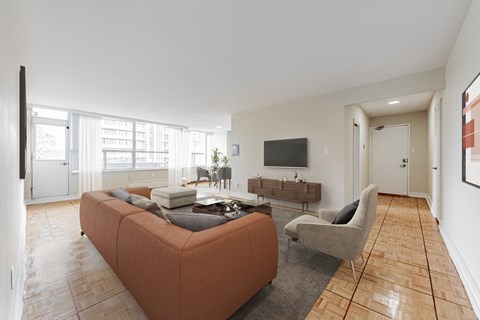 A living room with a couch, chair, and television.
