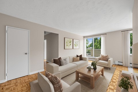 A living room with a white couch and a wooden coffee table.
