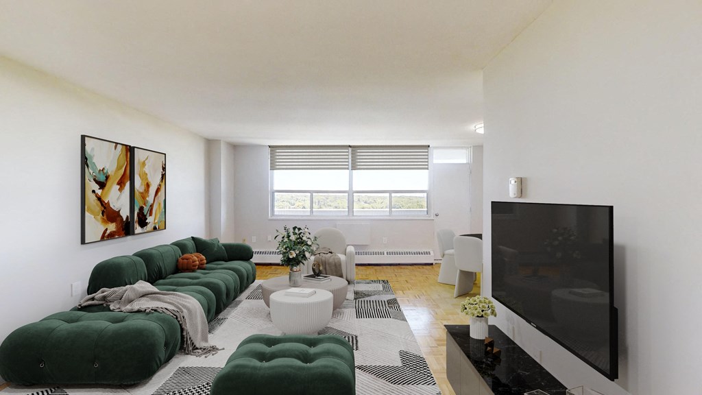 A living room with a green couch and a television.