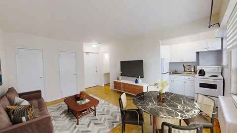 A living room with a brown couch, a coffee table, and a television.