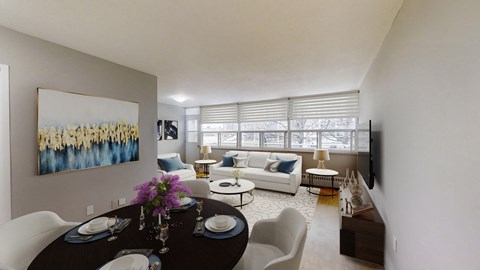 A dining room with a table set for two and a painting on the wall.