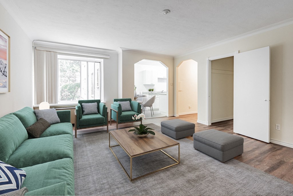 A living room with a green couch and a coffee table.